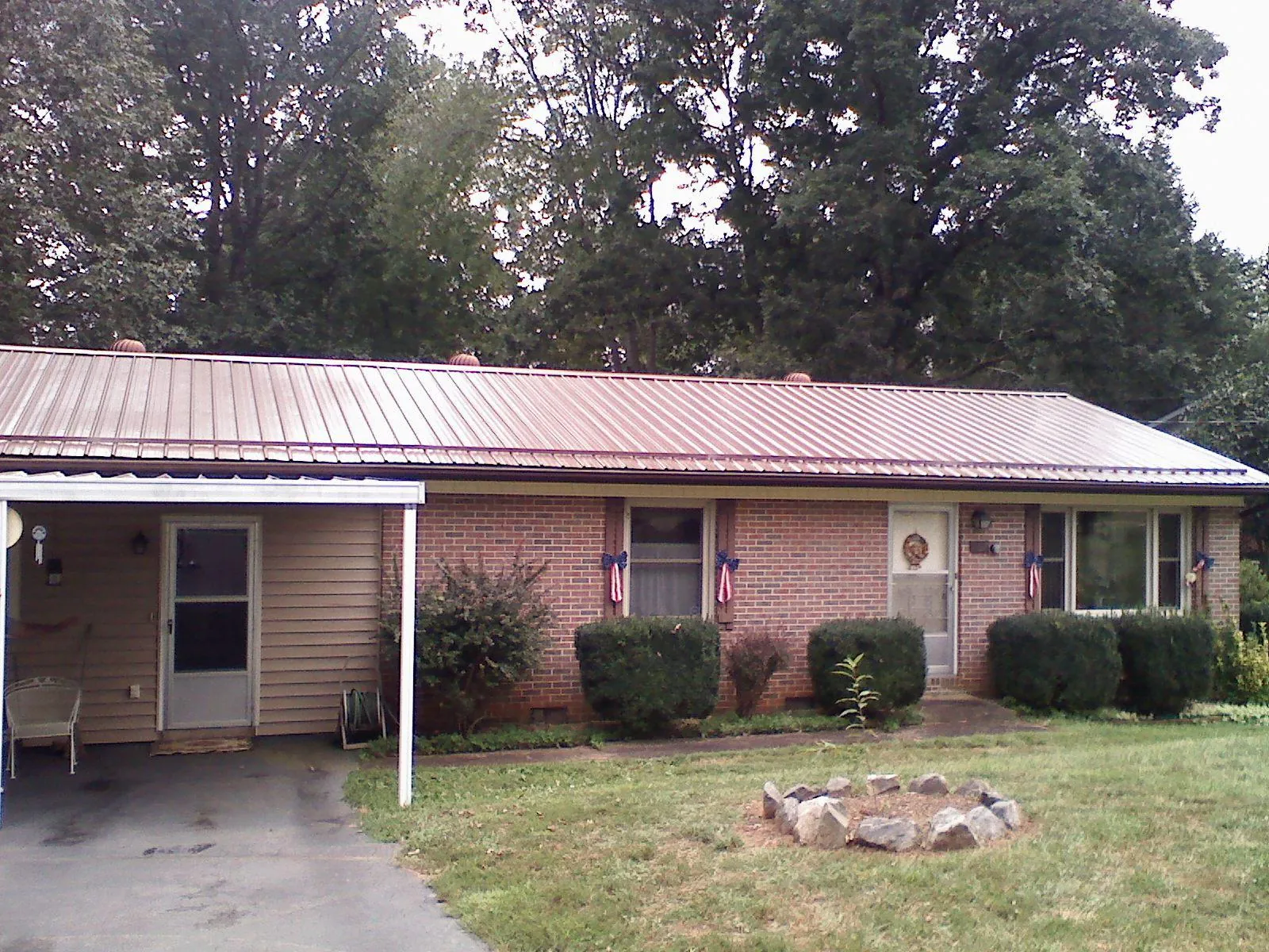 Bronze metal roof and carport on a brick ranch home — Roof Repair work by our crew in Brentwood