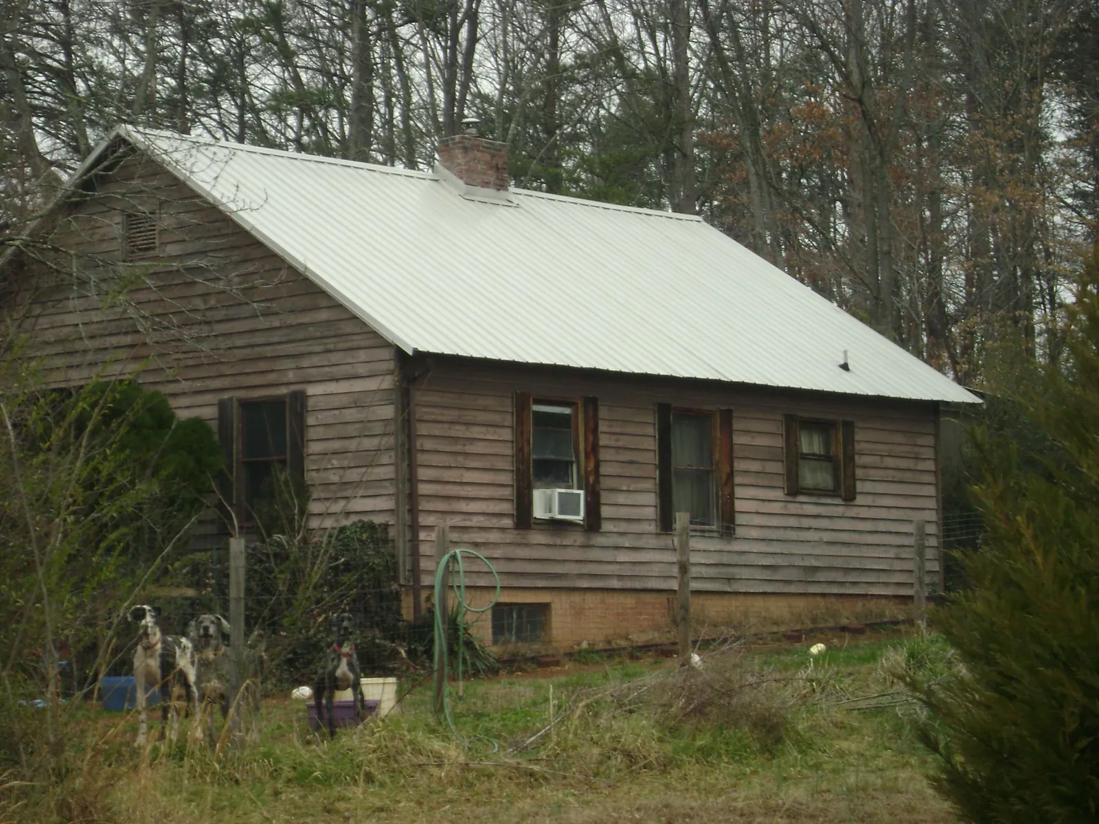 White metal roof on an old wood sided farmhouse, from a Metal Roof Installation job in Brentwood